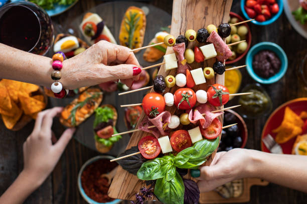 istock Offering and serving tapas to many people hands 1193568609