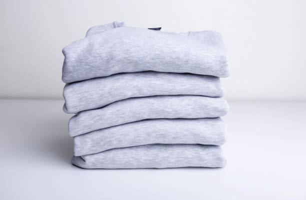 istock Stack of blank colorful sweatshirts closeup 1193570107