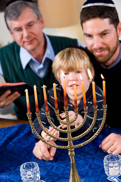 Jewish family lighting Chanukah menorah  hanukkah candles stock pictures, royalty-free photos & images