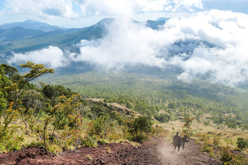 Bajawa - Una pareja bajando por una empinada ladera del volcán Inierie photo