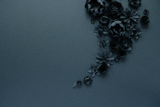 istock Black paper flowers on Black background. Cut from paper. 1193572544