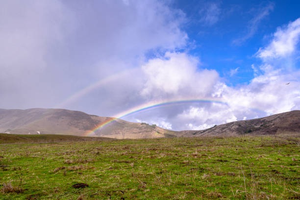istock Double Rainbow Over Field and Foothills 1193573863