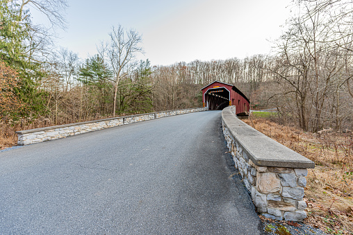 A quiet country road approaches Colemanville Covered Bridge in Lancaster County, Pennsylvania.