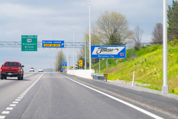 Welcome Center exit sign on highway in Virginia on interstate 381 and Tennessee Bristol, USA - April 19, 2018: Welcome Center exit sign on highway in Virginia on interstate 381 and Tennessee text with cars on road tennessee road sign stock pictures, royalty-free photos & images