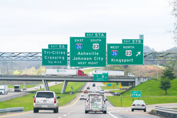Asheville and Johnson City exit sign on highway in Tennessee on interstate 81 road Bristol, USA - April 19, 2018: Asheville and Johnson City exit sign on highway in Tennessee on interstate 81 with cars on road kearney nebraska stock pictures, royalty-free photos & images