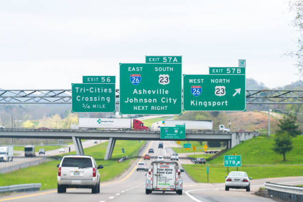 Asheville and Johnson City exit sign on highway in Tennessee on interstate 81 road Bristol, USA - April 19, 2018: Asheville and Johnson City exit sign on highway in Tennessee on interstate 81 with cars on road tennessee road sign stock pictures, royalty-free photos & images