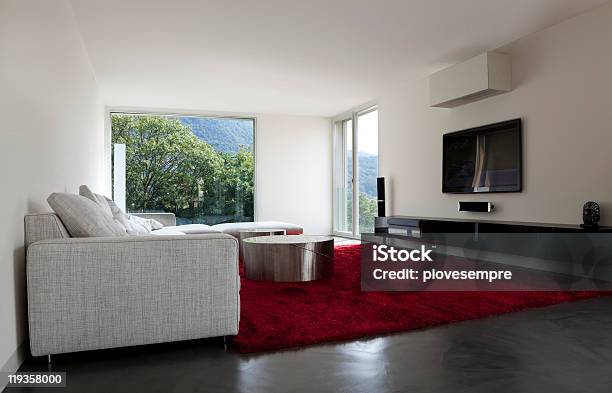 Modern Living Room With Red Carpet And Green Mountain View Stock Photo - Download Image Now