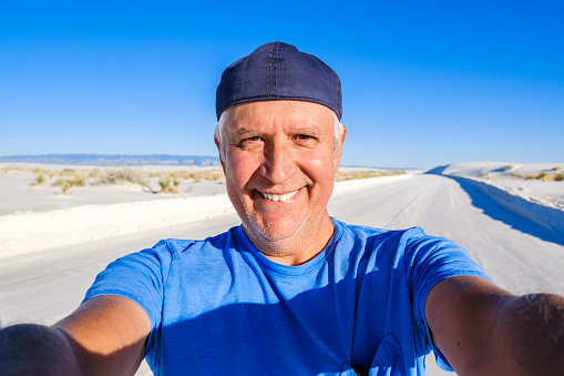 Handsome middle age man selfie enjoying the natural beauty of White Sands National Monument in New Mexico.