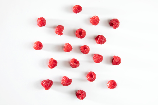 Fresh raspberries on white background from above view