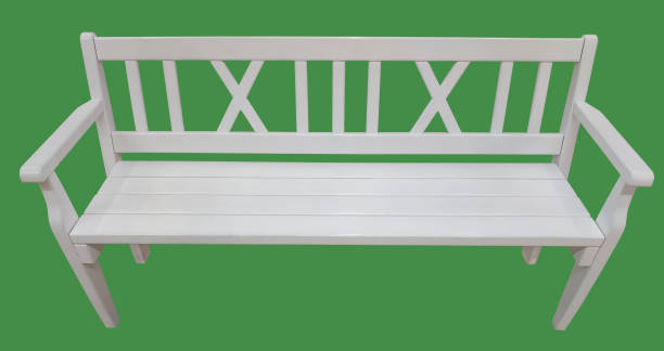 istock White wooden bench isolated on a green background. 1193583060