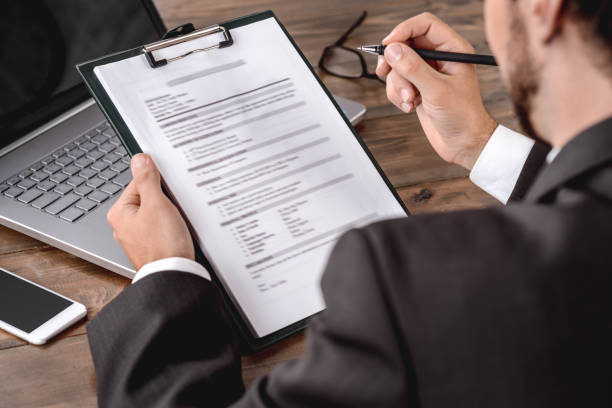 Employer filling candidate form sitting in office back view cllose-up stock photo
