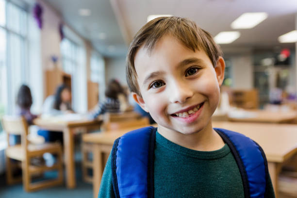 istock Cute young boy smiles for camera before leaving library 1193583380