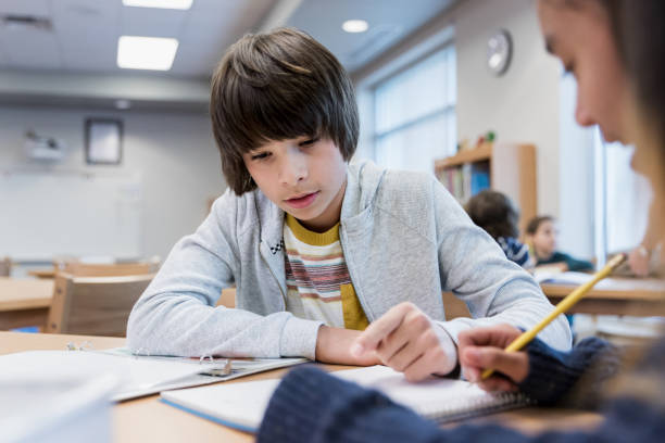 istock Two middle school friends do homework together at library 1193583387