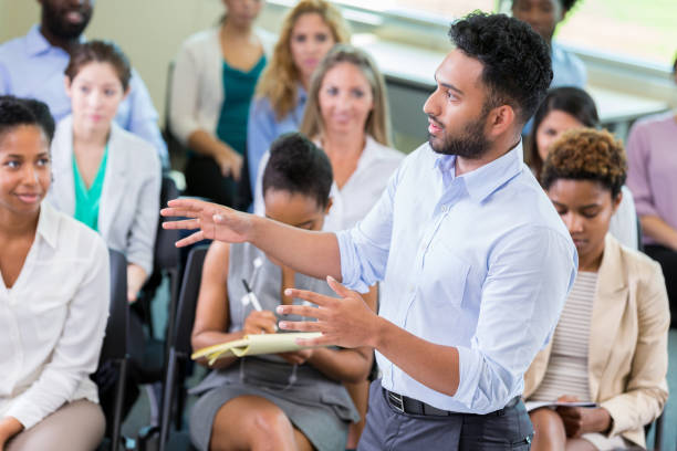 istock Businessman addresses the crowd during a seminar 1193583568