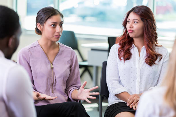 istock Vulnerable young woman shares during support group meeting 1193583580