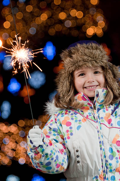 istock Young child in coat and hat holding a sparkler 119358516