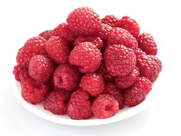 plateful of sweet fresh raspberries isolated on white stock photo