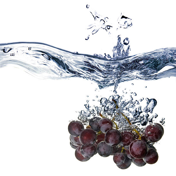 istock blue grape dropped into water with splash isolated on white 119360062