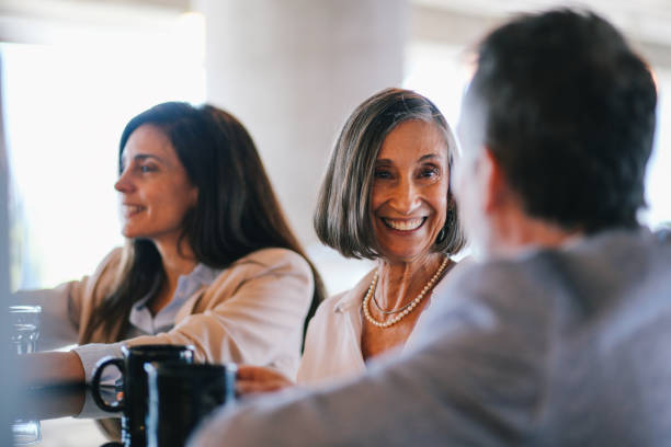 istock Coworkers sitting in a cafeteria 1193601681