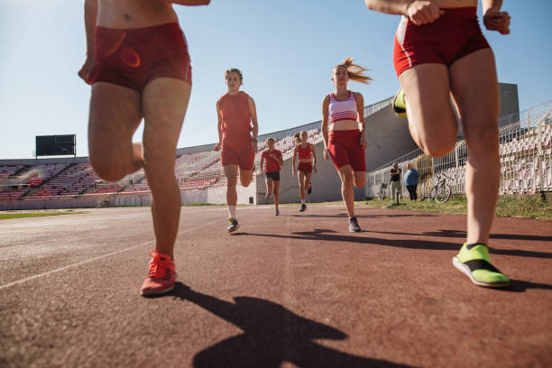 istock Young athletics team jogging for a warm up 1193601930