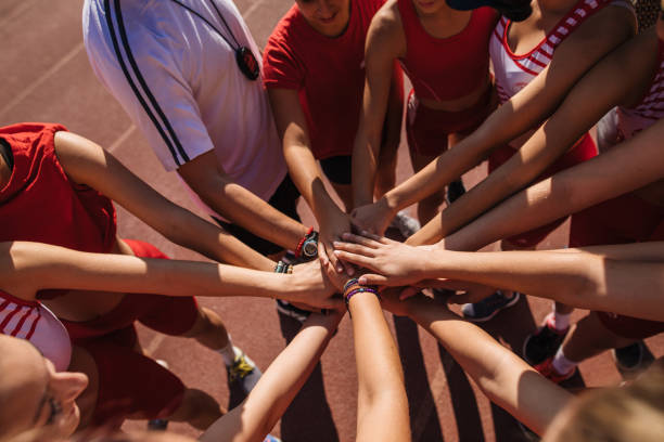 istock Athletics team putting hands together on a sports training 1193602005