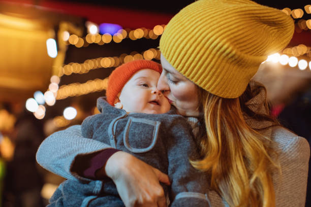 istock Mother kissing a baby 1193602624