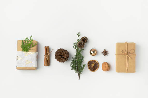 istock Christmas New Years composition with gift boxes pine cones cinnamon sticks dried oranges anise golden balls on white background 1193603696