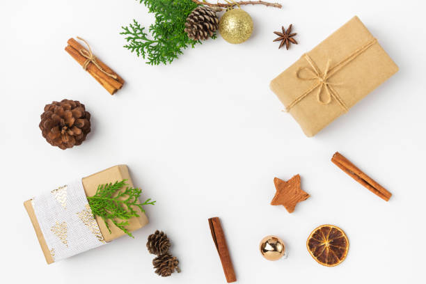 istock Christmas New Years composition with gift boxes pine cones cinnamon dried oranges anise golden balls on white background 1193603723