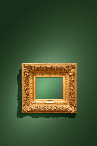 istock Golden empty antique picture frame hanging on green wall 1193605496