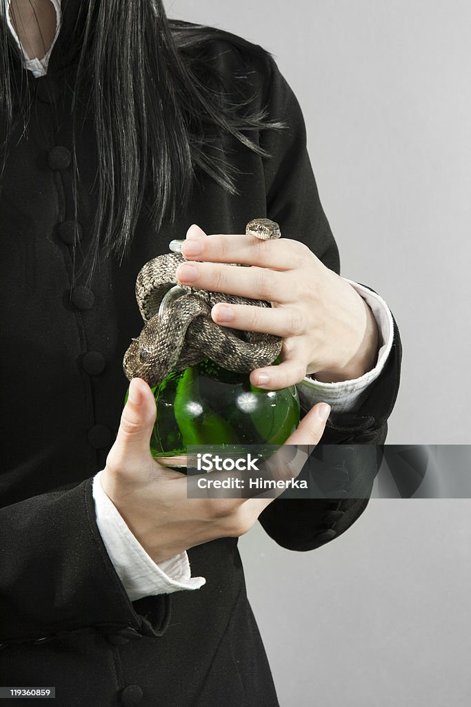 The person hold poison with a snake  Buying Stock Photo
