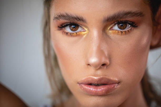 istock Gorgeous young woman with golden make-up 1193608664