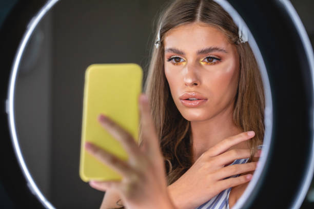 istock Gorgeous young woman with beautiful make-up doing selfies 1193609432
