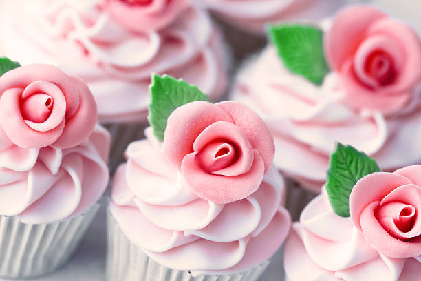 istock Beautifully frosted cupcakes with pink icing and roses 119361206