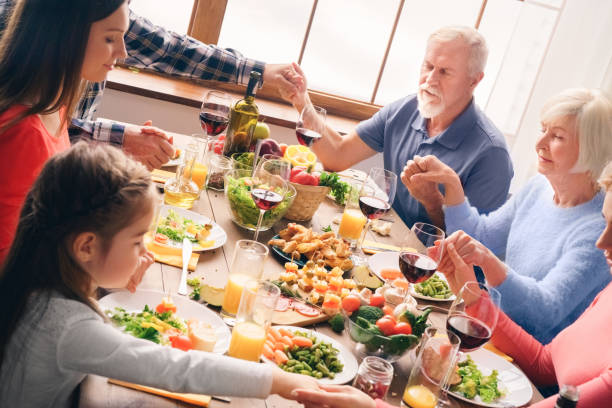 istock Prayer before meals, catholics pray. Holding hands 1193614027