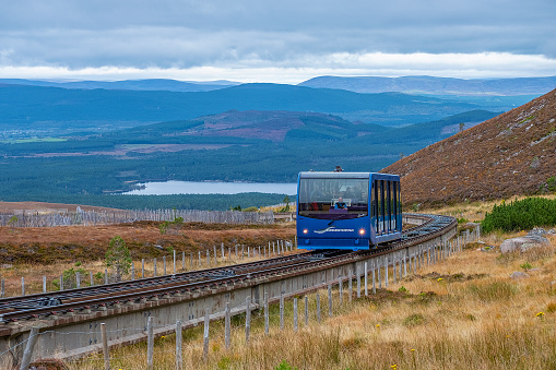 Cairngorm Mountain, Scottish Highlands, UK - October 10, 2019: blue tramcar taking tourist up to the famous Cairngorm Mountain