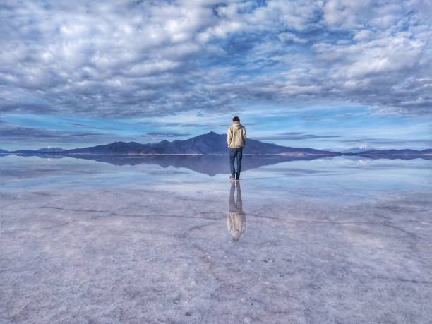 Man at Salar de Uyuni, the largest salt flat in the world, Bolivia, South America stock photo