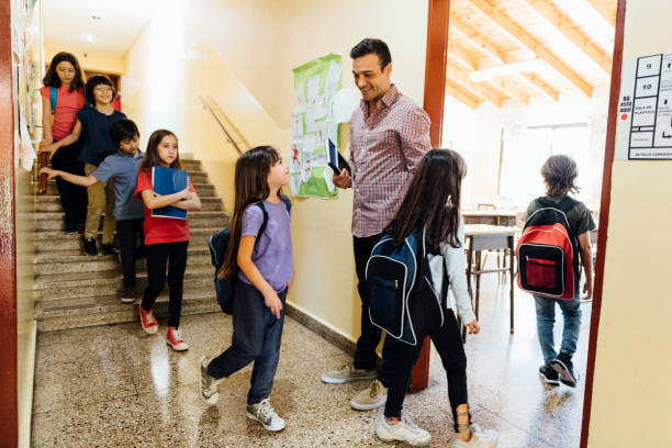 istock Teacher Welcoming Students to Class 1193619862