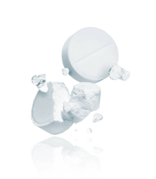 istock Crushed and whole pills closeup isolated on a white background 1193621207