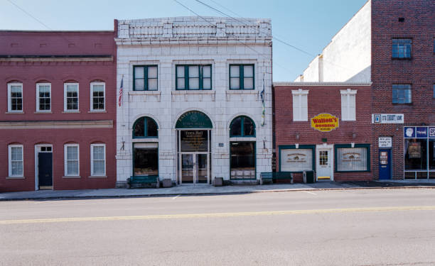 Fayetteville West Virginia, November 14th, 2019: A few brick buildings bisected by a white stone building along an empty street in the morning.