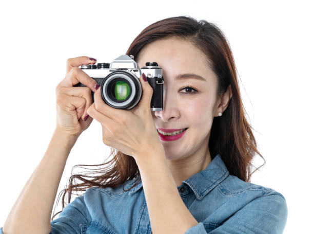 istock Beautiful woman holding a SLR camera on white background 1193628012