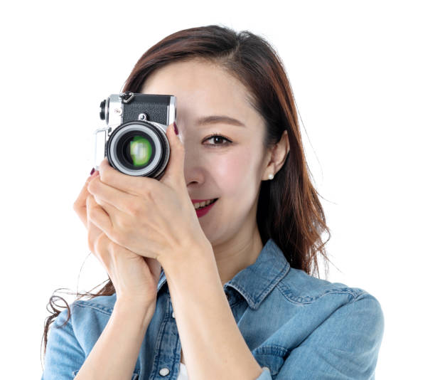 istock Beautiful woman holding a SLR camera on white background 1193628066