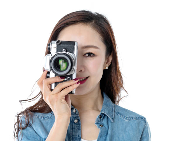 istock Beautiful woman holding a SLR camera on white background 1193628078