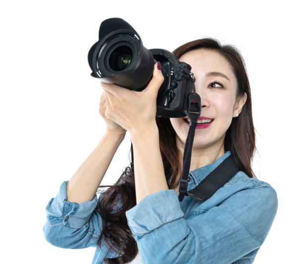 istock Woman holding professional digital camera on white background 1193628152