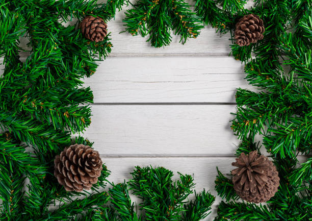 istock Fir branches and Pine cones on white wooden board 1193628338