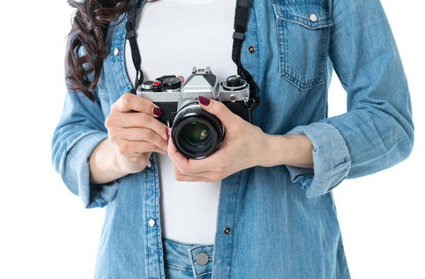 istock Woman hand holding a SLR camera on white background 1193628422