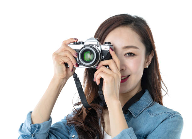 istock Beautiful woman holding a SLR camera on white background 1193628501