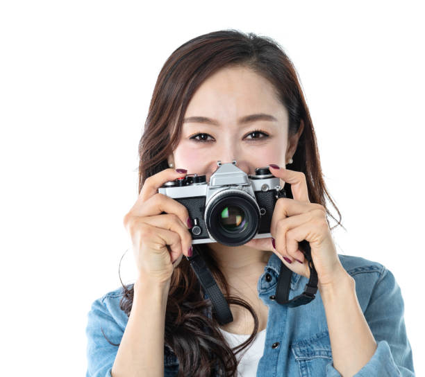 istock Beautiful woman holding a SLR camera on white background 1193629030