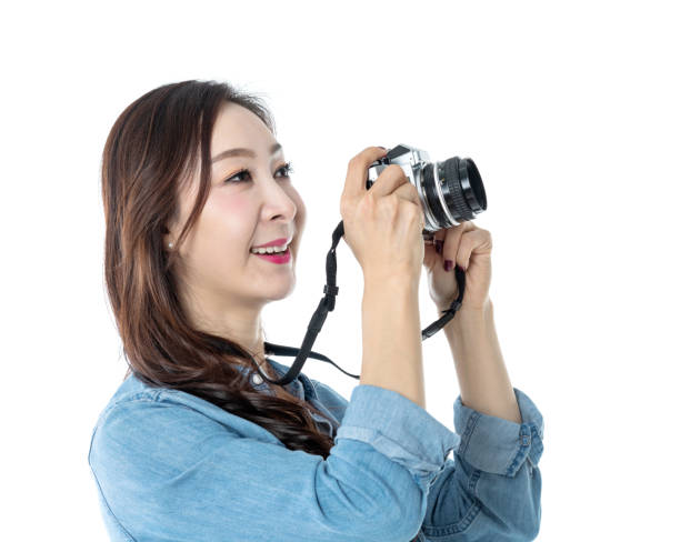 istock Beautiful woman holding a SLR camera on white background 1193629062