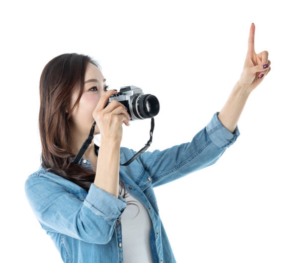 istock Woman holding a SLR camera and pointing up 1193629115