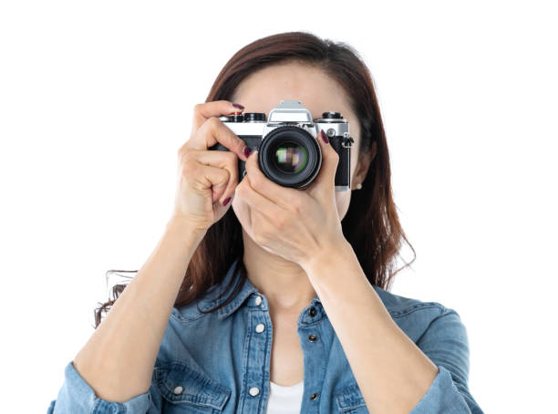istock Beautiful woman holding a SLR camera on white background 1193629138